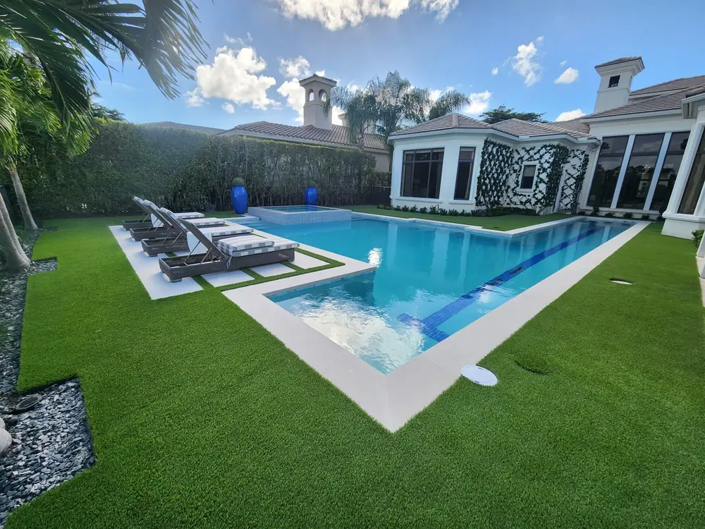 Rectangular pool framed by wraparound artificial turf